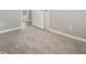Spacious carpeted bedroom with an open door to another room at 100 Spicewood Ct, South Fulton, GA 30349