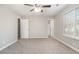 Spacious bedroom with ceiling fan, neutral walls, and carpeted floor at 100 Spicewood Ct, South Fulton, GA 30349
