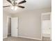 Primary bedroom with ceiling fan, neutral walls, and carpeted floor at 100 Spicewood Ct, South Fulton, GA 30349