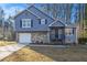 Newly renovated blue house with stone accents and a large yard at 100 Spicewood Ct, South Fulton, GA 30349
