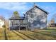 Rear view of house showing gray siding and deck at 100 Spicewood Ct, South Fulton, GA 30349