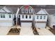Aerial view of three-story townhome with two-car garage at 257 Whitetail Cir, Canton, GA 30115