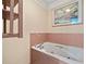 Relaxing bathroom with a jetted tub and tiled walls at 7312 Melrose Ct, Villa Rica, GA 30180