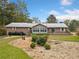 Brick house with a sunroom, deck, and partially fenced backyard at 7312 Melrose Ct, Villa Rica, GA 30180