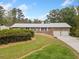 Brick ranch house with attached two-car garage and landscaped yard at 7312 Melrose Ct, Villa Rica, GA 30180