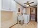 Bright laundry room with washer, dryer, cabinets, and utility sink at 7312 Melrose Ct, Villa Rica, GA 30180