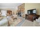 Living room with stone fireplace, comfy sofas, and a large TV at 7312 Melrose Ct, Villa Rica, GA 30180