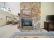 Living room showcasing a large stone fireplace as a focal point at 7312 Melrose Ct, Villa Rica, GA 30180