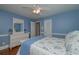 Bedroom with light blue walls, hardwood floors and ceiling fan at 2192 Weslan Dr, Austell, GA 30106