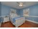 Bedroom with light blue walls, hardwood floors and ceiling fan at 2192 Weslan Dr, Austell, GA 30106