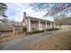 Brick ranch house with long driveway, landscaping, and detached garage at 2192 Weslan Dr, Austell, GA 30106