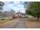 Side view of brick ranch house with long driveway and detached garage at 2192 Weslan Dr, Austell, GA 30106