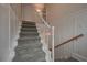 Gray carpeted stairs with white railings and wood handrail at 2192 Weslan Dr, Austell, GA 30106