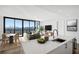 Modern kitchen with white cabinetry, quartz countertops, and island with seating at 2425 Peachtree Ne Rd # 1106, Atlanta, GA 30305
