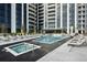 Resort-style pool and hot tub with plenty of lounge chairs at 2425 Peachtree Ne Rd # 1106, Atlanta, GA 30305