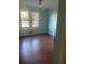 Bedroom with hardwood floors and light teal walls at 3262 Carriage Way, Marietta, GA 30062