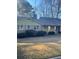 Ranch home with light green siding and mature landscaping at 3262 Carriage Way, Marietta, GA 30062