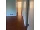 Hallway with hardwood floors leading to other rooms at 3262 Carriage Way, Marietta, GA 30062