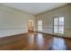 Living room with hardwood floors, plantation shutters, and entryway view at 1216 Valley Dr, Conyers, GA 30012