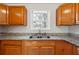 Bright kitchen featuring granite countertops and wood cabinets at 3683 Rolling Pl, Conley, GA 30288
