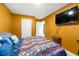 Bedroom with mustard colored walls and a queen bed at 11961 Lovejoy Crossing Way, Hampton, GA 30228