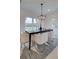 Elegant dining room with a dark wood table, white chairs, and a modern chandelier at 412 Carrera Ln, Acworth, GA 30102