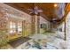 Stone patio with wood ceiling, fans and seating at 6206 Zell Miller Nw Path, Acworth, GA 30101