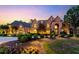 Luxury two-story home with stone exterior, landscaping, and lighting at dusk at 6206 Zell Miller Nw Path, Acworth, GA 30101