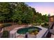 Luxury pool with spa and waterfall feature, surrounded by a stone patio at 6206 Zell Miller Nw Path, Acworth, GA 30101