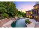 Elegant pool and spa with waterfall feature, stone patio, and beautiful landscaping at 6206 Zell Miller Nw Path, Acworth, GA 30101