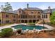 Inviting freeform pool with brick patio and lush landscaping at 6206 Zell Miller Nw Path, Acworth, GA 30101