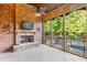 Screened porch with fireplace, brick wall, and view of pool at 6206 Zell Miller Nw Path, Acworth, GA 30101