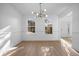 Bright dining room with hardwood floors and a modern light fixture at 2332 Brandenberry Ct, Decatur, GA 30034