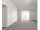 Large bedroom with grey carpet and double doors at 116 Rolling Meadows Ct, Hampton, GA 30228