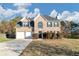 Brick two-story house with attached two-car garage and landscaping at 116 Rolling Meadows Ct, Hampton, GA 30228