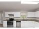 Modern kitchen with stainless steel appliances and granite countertops at 116 Rolling Meadows Ct, Hampton, GA 30228