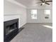 Spacious living room with fireplace and gray carpeting at 116 Rolling Meadows Ct, Hampton, GA 30228