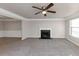 Living room with gray carpet, fireplace and ceiling fan at 116 Rolling Meadows Ct, Hampton, GA 30228