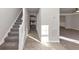 Gray carpeted staircase with a white railing at 116 Rolling Meadows Ct, Hampton, GA 30228