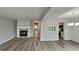 Spacious living room with hardwood floors, a stone fireplace, and access to other rooms at 2683 Meadowlawn Se Dr, Marietta, GA 30067