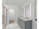 Modern bathroom with double vanity, large mirror, and walk-in shower at 3328 Pepperpike Ct, Loganville, GA 30052
