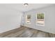 Bright bedroom with wood-look floors and two large windows at 3328 Pepperpike Ct, Loganville, GA 30052