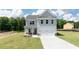 Two-story house with gray siding, a two-car garage, and a landscaped lawn at 3328 Pepperpike Ct, Loganville, GA 30052