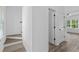 Bright hallway with stairs, wood-look floors, and doors to other rooms at 3328 Pepperpike Ct, Loganville, GA 30052