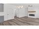Open living room with chandelier, fireplace, and hardwood floors at 3328 Pepperpike Ct, Loganville, GA 30052