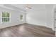Main bedroom with ceiling fan, wood-look floors, and large windows at 3328 Pepperpike Ct, Loganville, GA 30052