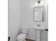 Small, clean powder room with pedestal sink and white toilet at 3328 Pepperpike Ct, Loganville, GA 30052