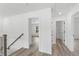 Spacious hallway connecting bedrooms and bathroom; features wood-look floors at 3328 Pepperpike Ct, Loganville, GA 30052