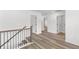 Upstairs hallway with light wood-look floors and access to bedrooms and bathroom at 3328 Pepperpike Ct, Loganville, GA 30052