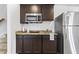 Basement kitchenette with microwave, granite countertops, and full-size refrigerator at 819 Major Oak Ct, Villa Rica, GA 30180
